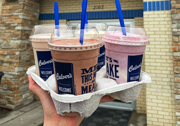 Four colorful concrete mixers in a holder